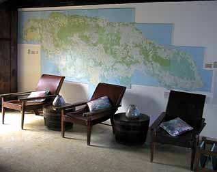 A huge map of Jamaica decorates this living room wall.