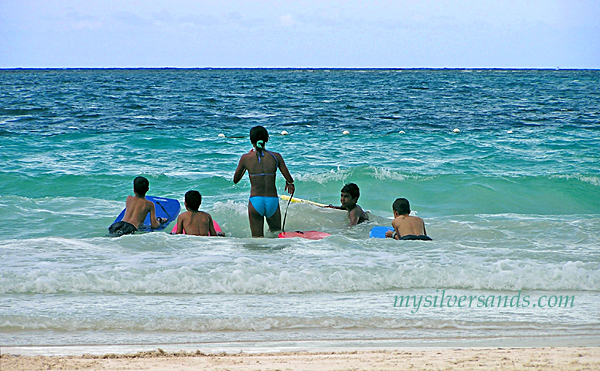 silver sands beach with kids bodysurfing in the waves