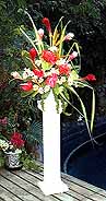 bride with pedestal floral arrangement