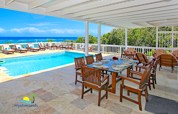 outdoor dining with view of the pool and caribbean sea