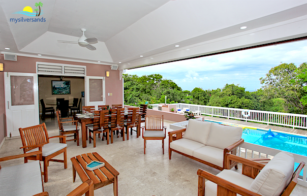outdoor dining and lounge area overlooking the pool