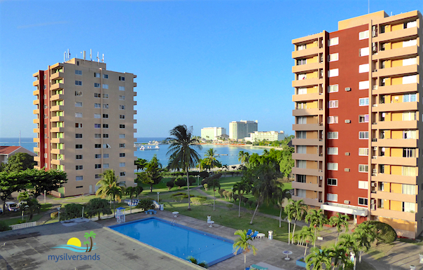 view of tower blocks, pool and sea view