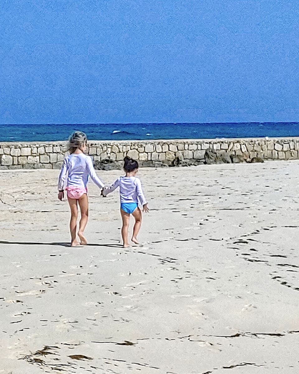 two sisters walking on the beach