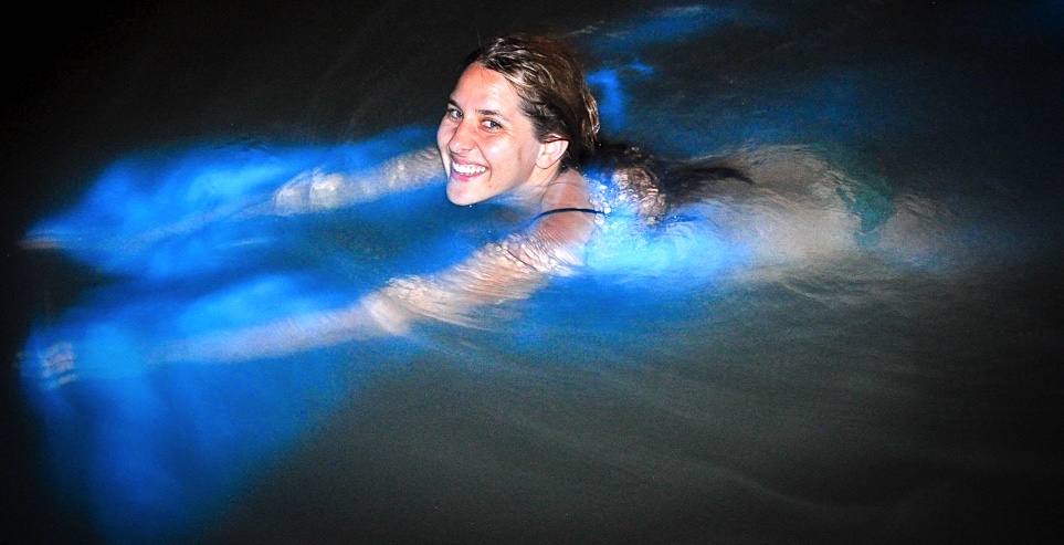 woman swimming in the luminous lagoon