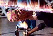 limbo dancer with fire on top and below