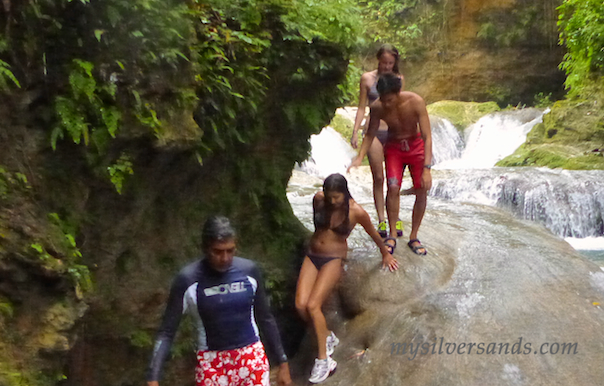 climbing down the rocks beside the river at blue hole