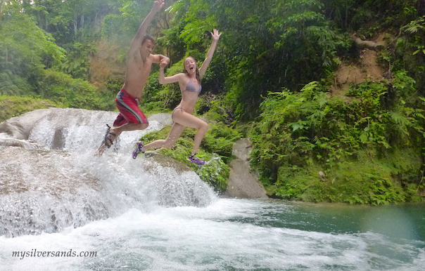 couple jumping into pool at blue hole in ocho rios jamaica