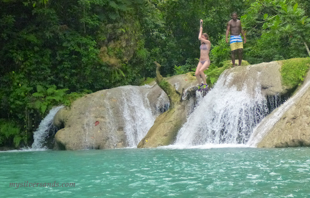 swinging on a rope into the blue hole first waterfall in ocho rios jamaica