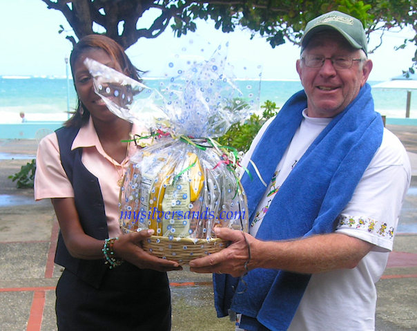 kimesha presents gift basket to vincent foltz at silver sands villas jamaica