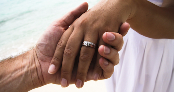 holding hands with wedding ring