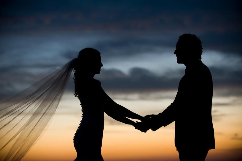 newlywed couple at sunset after destination wedding