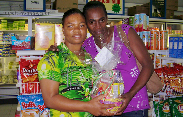Cynthia of Tu Mac' Villa in Silver Sands Jamaica receiving her gift basket from Mavoy of Villa Mart