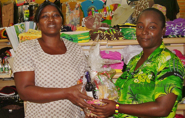 Ingrid of Hang Time with Arlene from Villa Mart receiving her gift basket at Silver Sands Jamaica