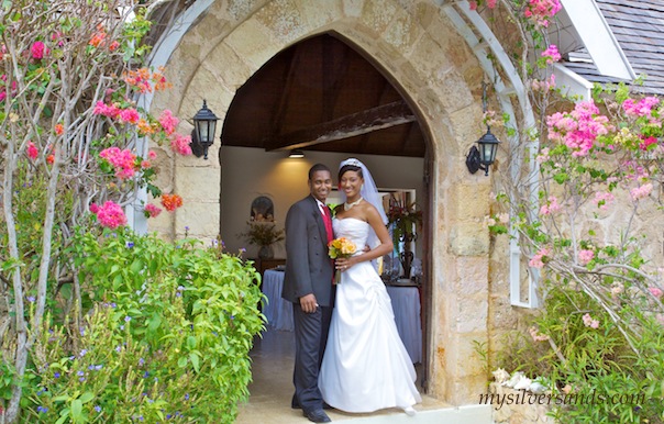 bride and groom at entrance arch to rum jetty at silver sands villas jamaica