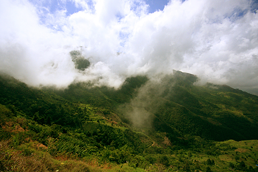 clouds rising from blue mountains