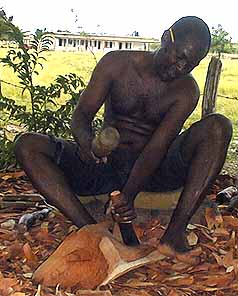 Wood carver, Spence, at work on one of his friend with a bend