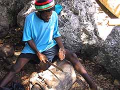 Ringo, the wood carver, at work on the fisherman's beach