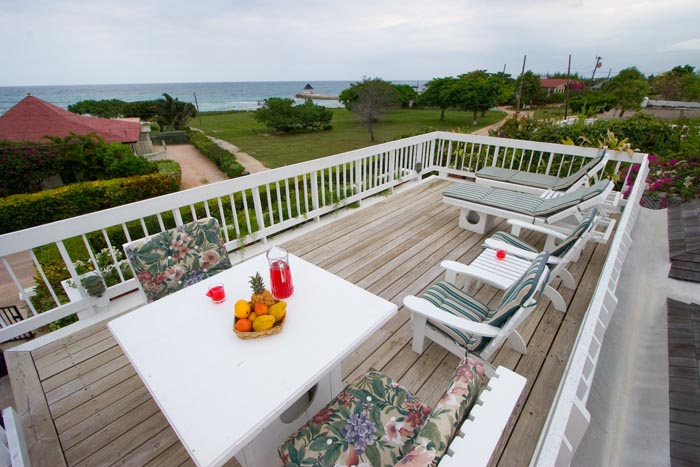 sundeck with lounge chairs, table, sea view