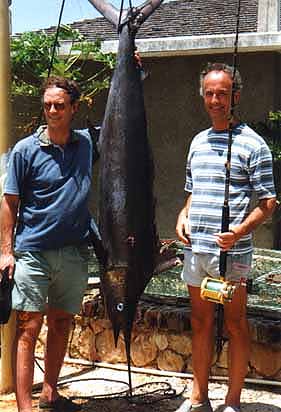 posing with their catch from deep sea fishing