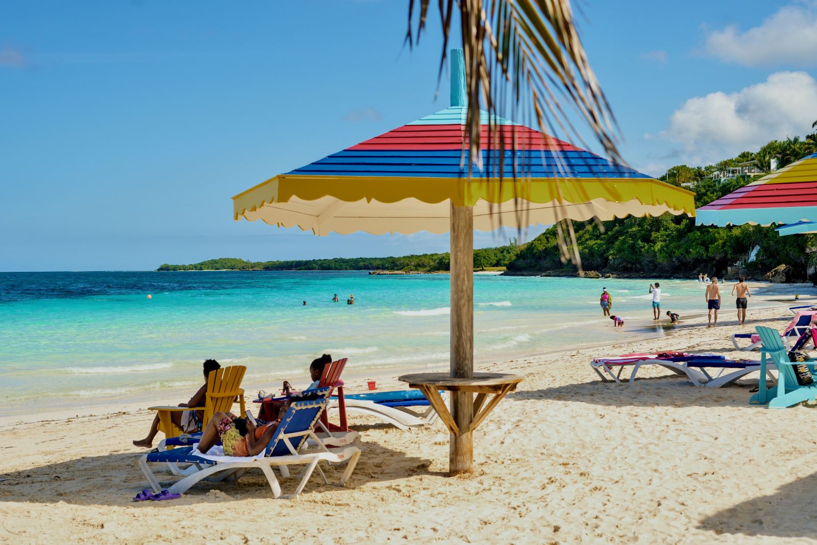 silver sands beach with cabanas and people to the ne