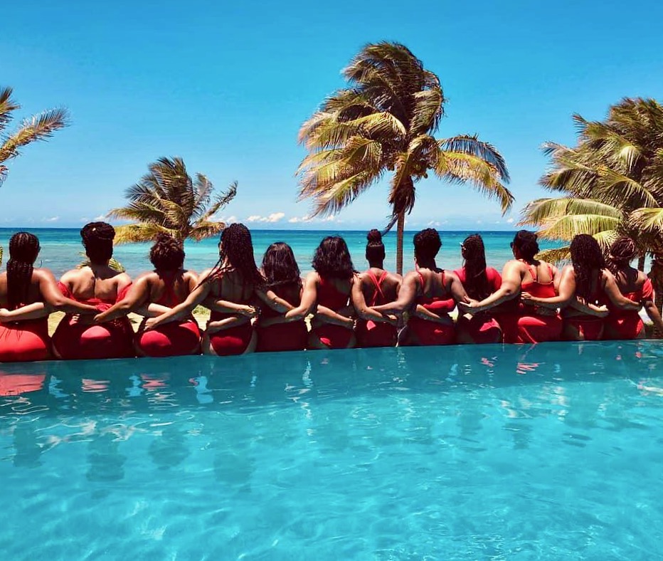 ladies in red sitting on the pool wall at Tallawah