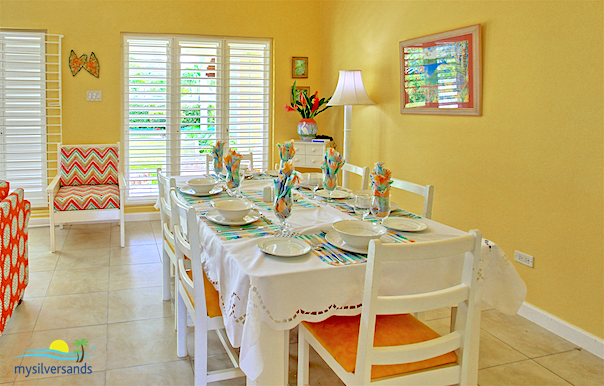 the dining room is next to the kitchen and the living room