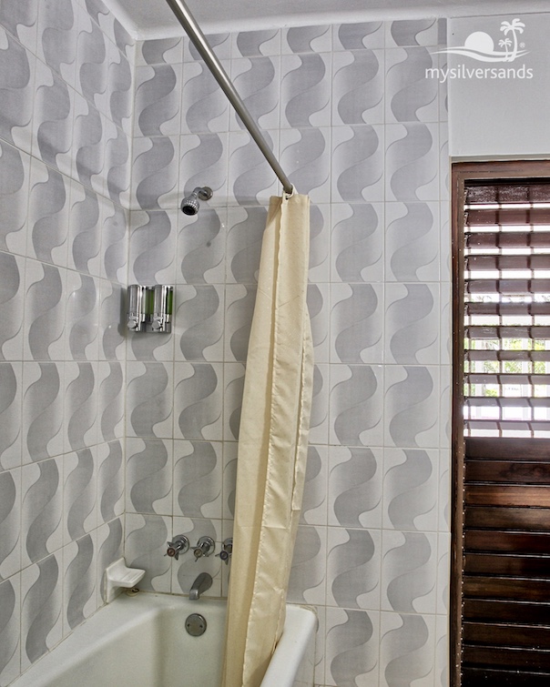 bathroom with shower over bathtub