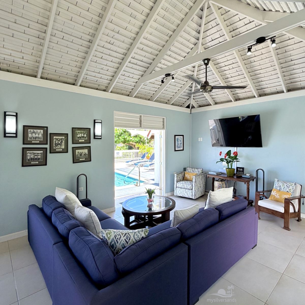 living room with tv to pool deck