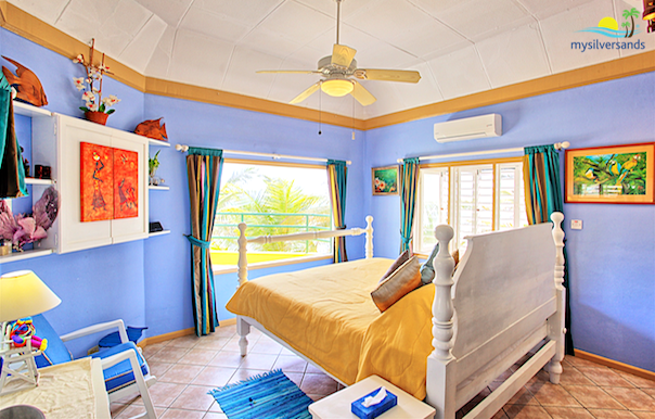 bedroom 1 with views of the coconut trees and the Caribbean Sea