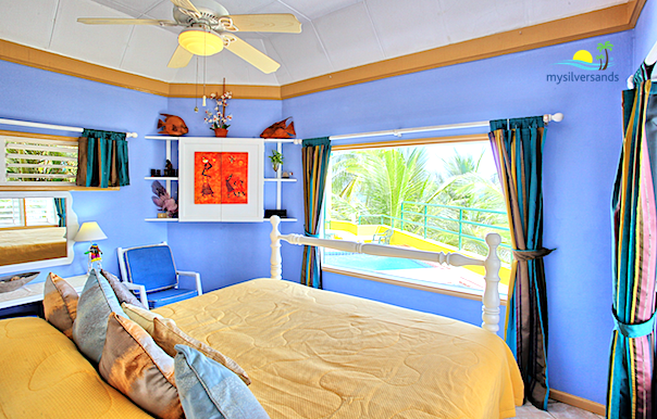 bedroom with television hidden behind wall-mounted cupboard