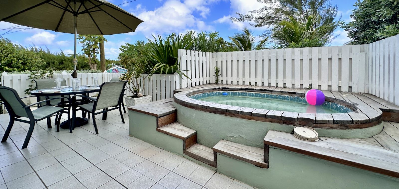 Patio with hot tub and outdoor dining