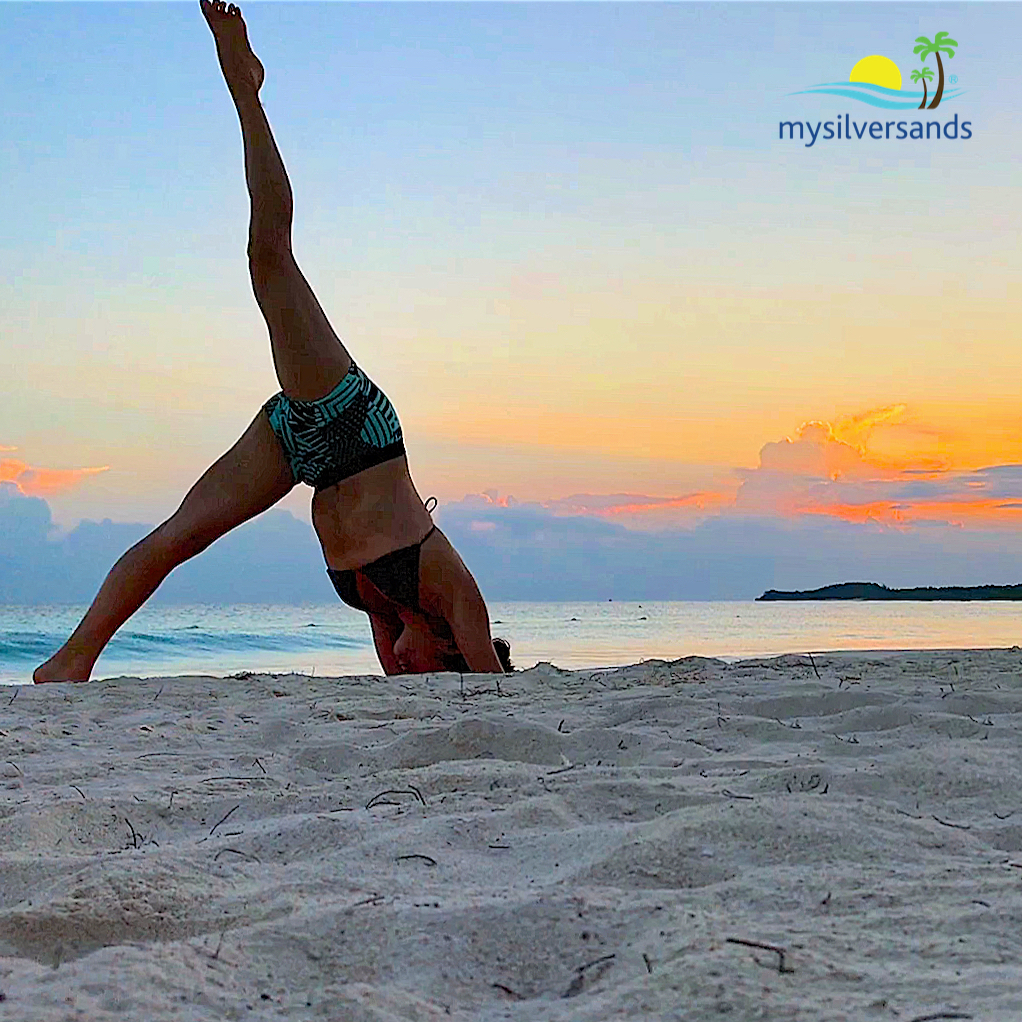 yoga on the beach at queen's cottage