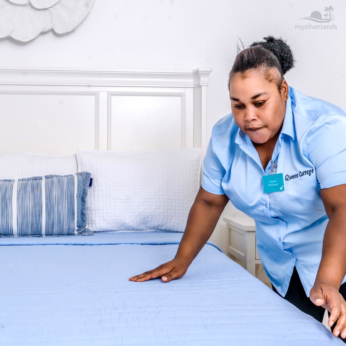 housekeeper making the bed