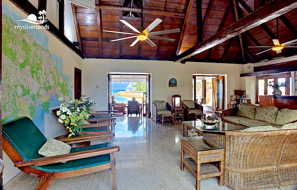 living room with large map of jamaica mounted pin the wall