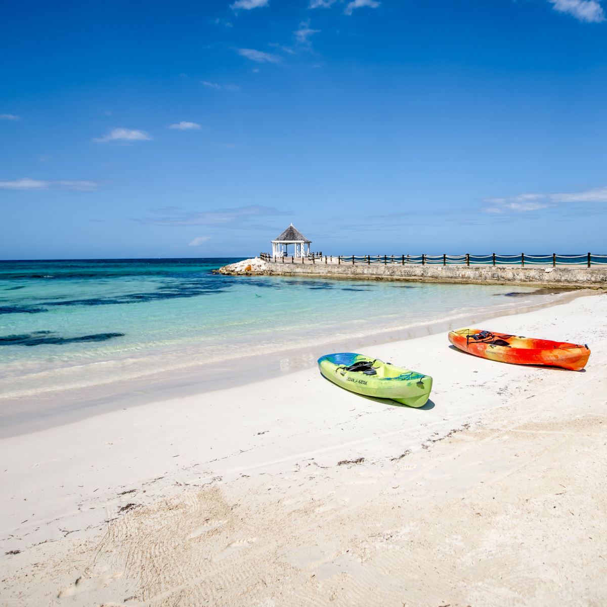 rum jetty beach with kayaks and view of gazebo on the jetty