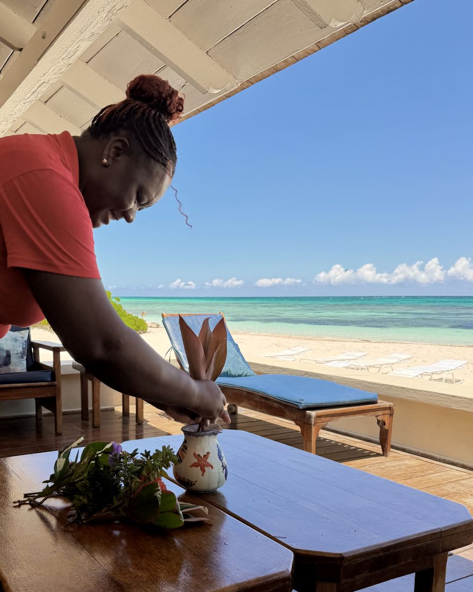 housekeeper at rum jetty arranging flowers