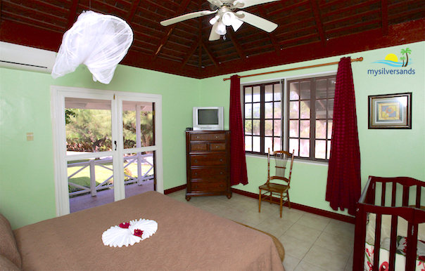 bedroom 2 with double doors opening out to the balcony