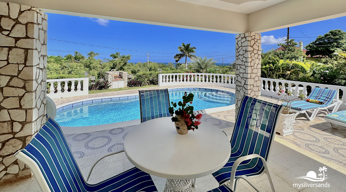 small table on the verandah beside the pool