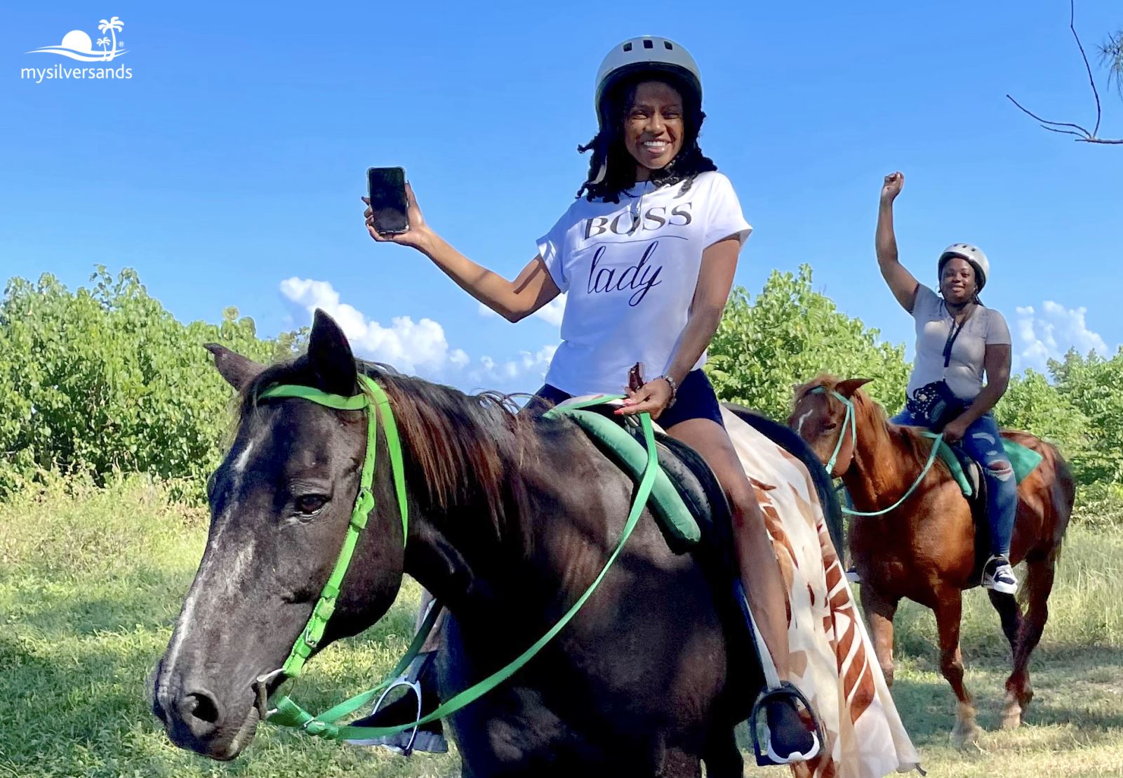 2 women on horseback on the trail