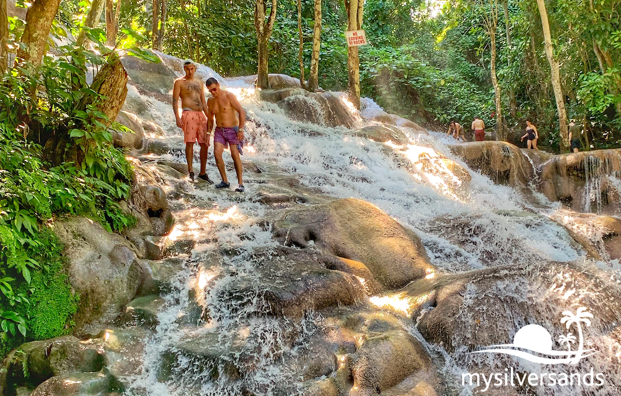 2 guys climbing down the falls