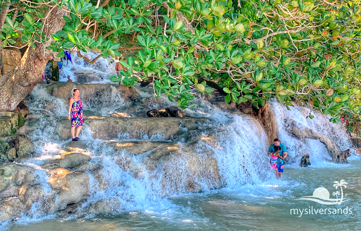 dressed woman standing on the falls