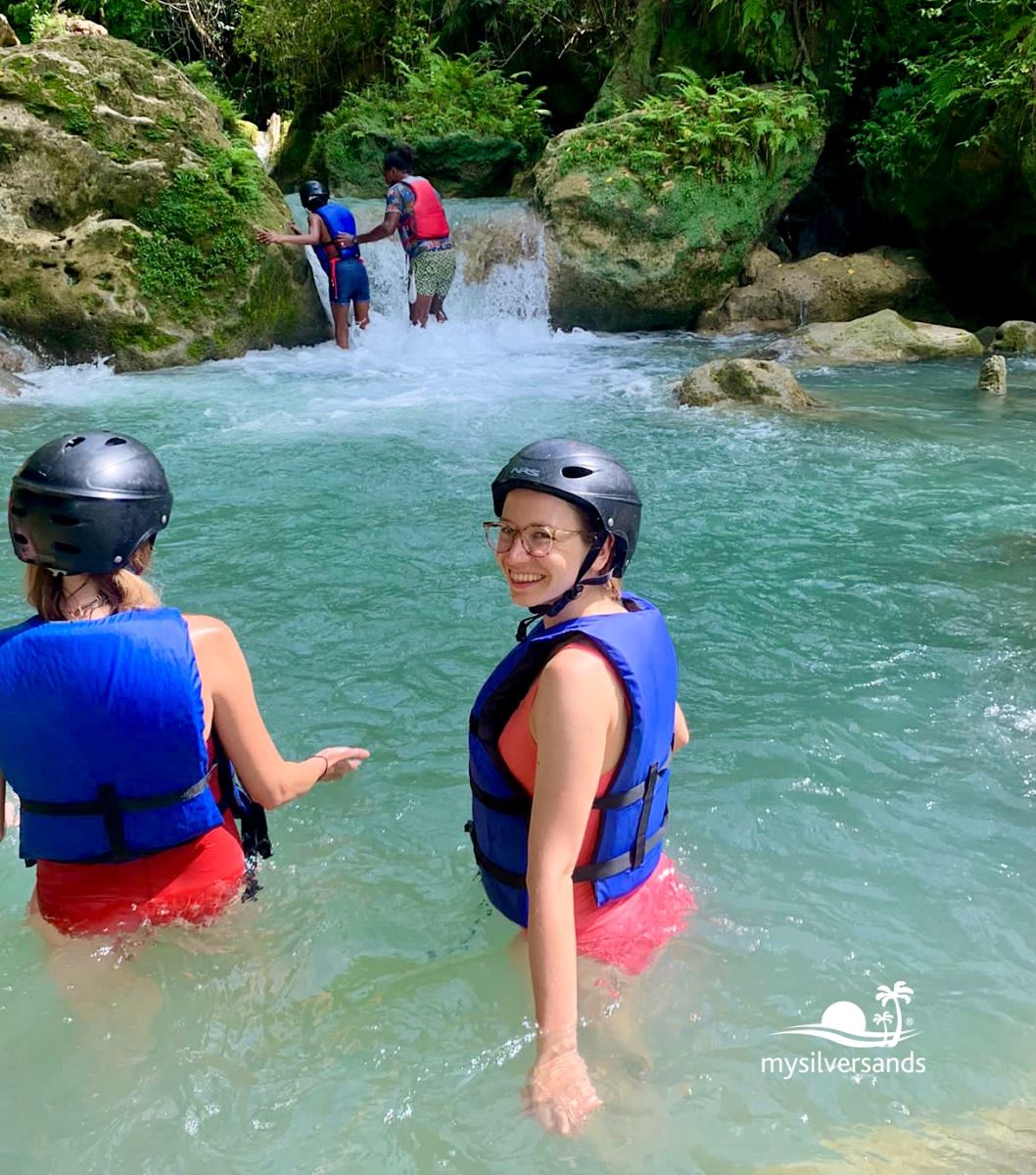 in the river by the waterfall