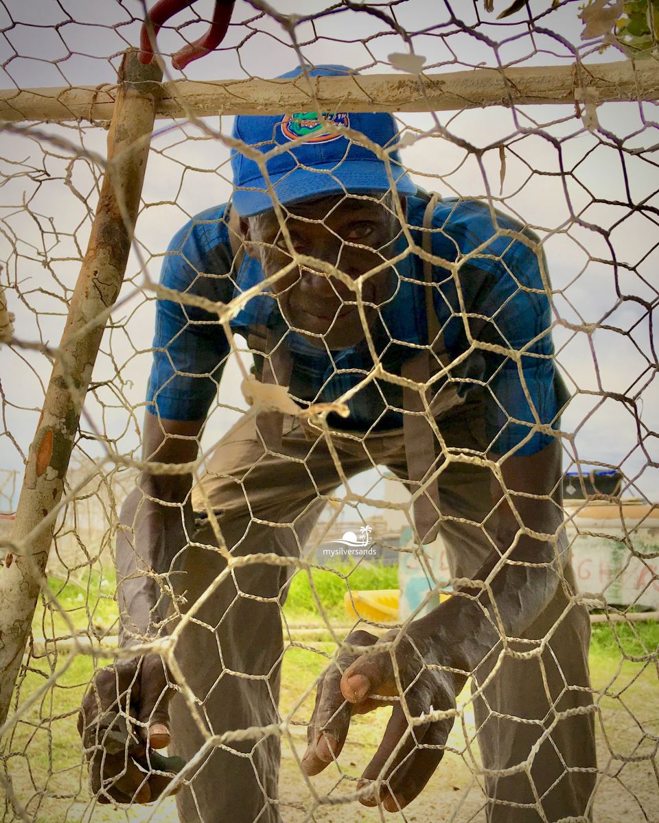 charles meggie through mesh of the fishpot