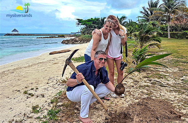 neal family plant a coconut tree at silver sands jamaicsa