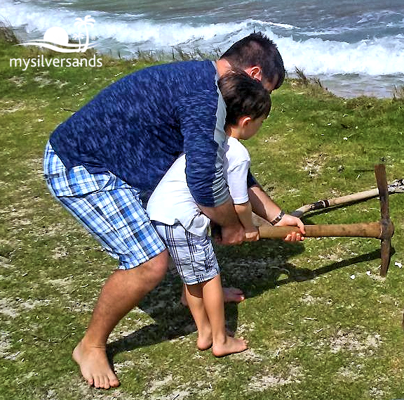 father and son digging the hole