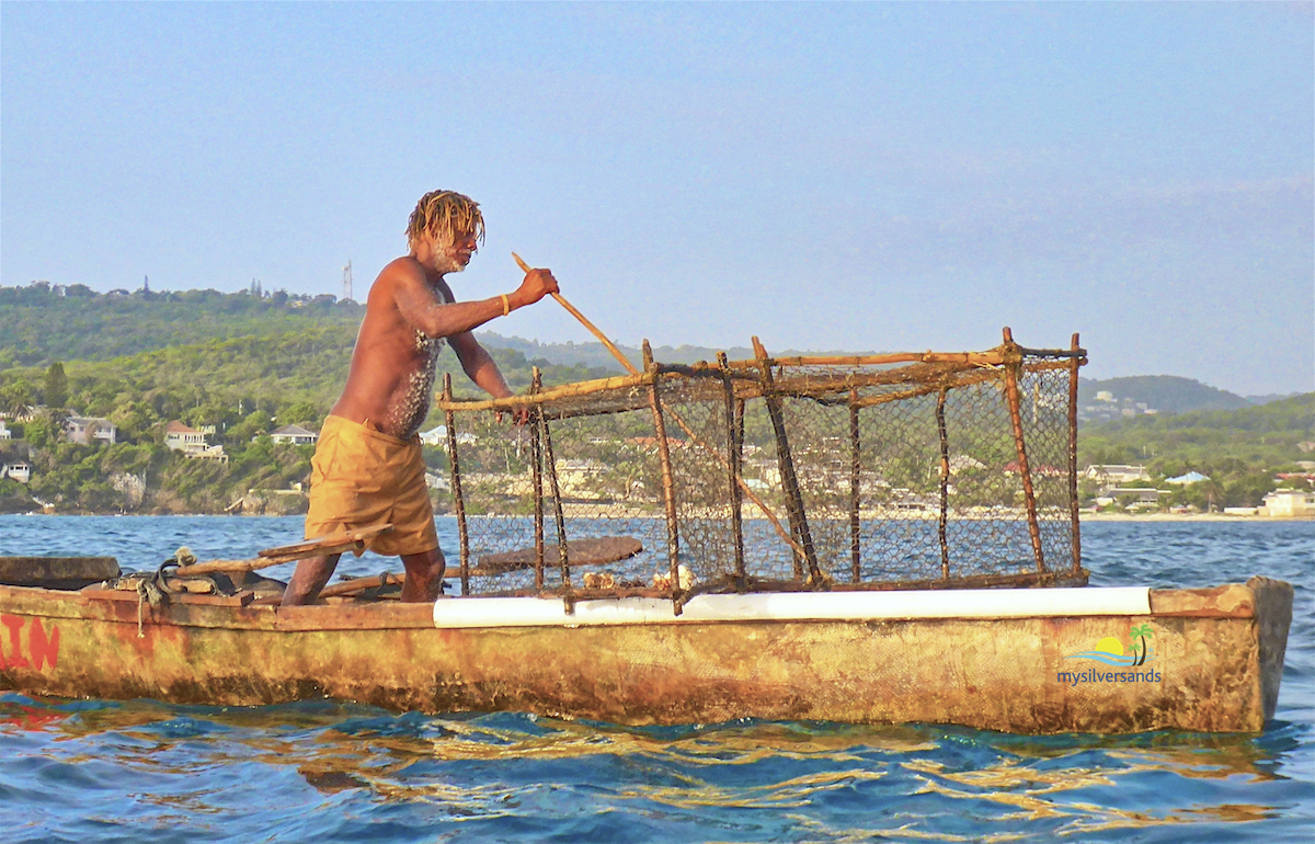 zion with his pole for extracting the fishes from the trap