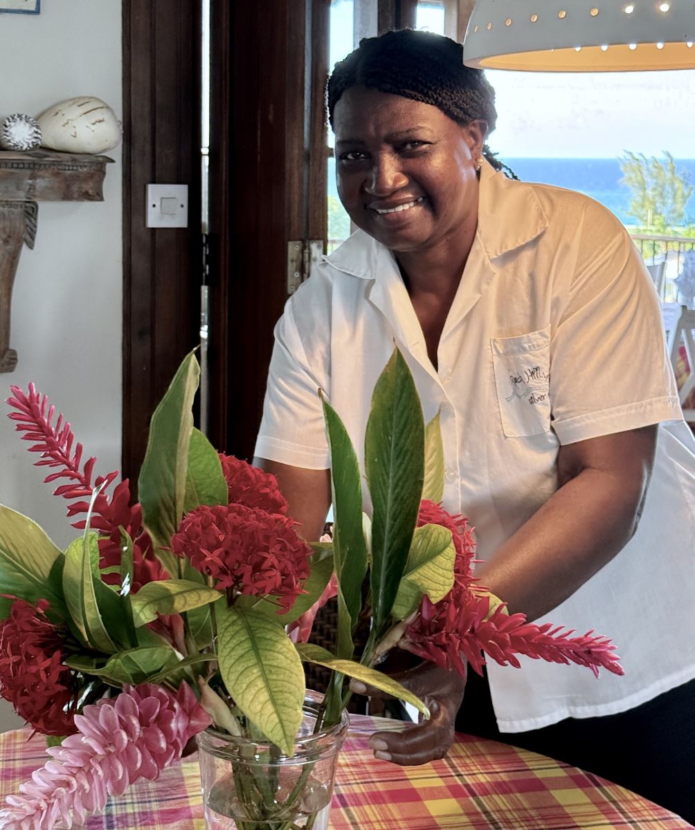 housekeeper arranging flowers