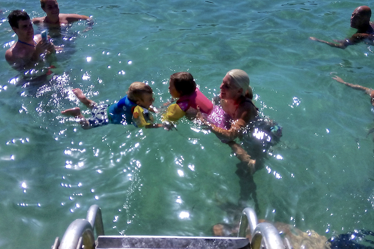 group in sea near boat