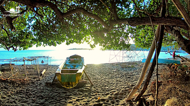 sunrise at the beach - boats and fish pots