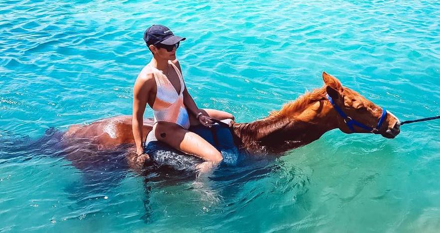 woman on horseback riding in the sea